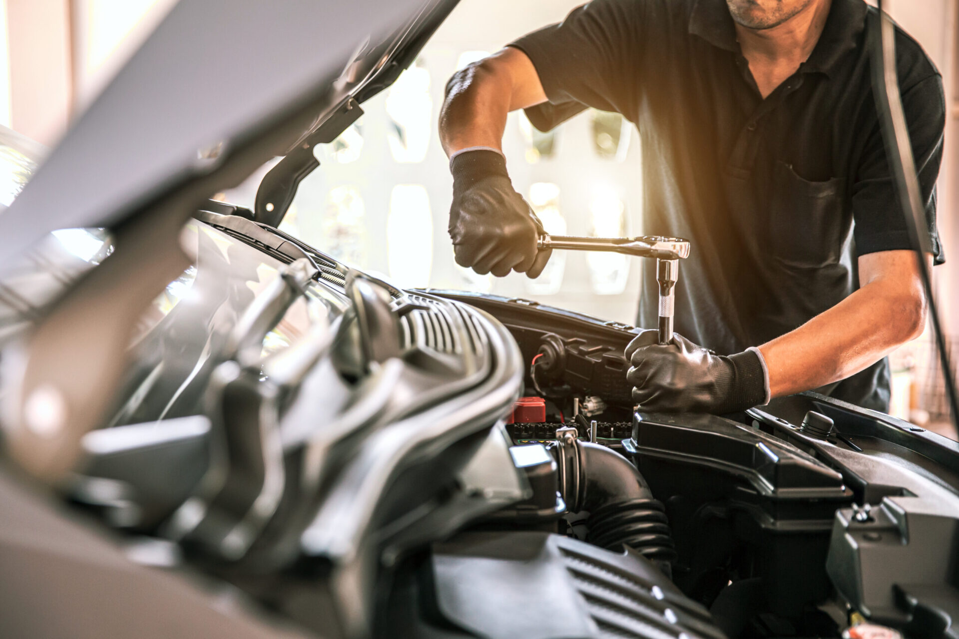 Close-up hand auto mechanic using the wrench to repairing car engine problem. Concepts of check and fix car and maintenance servicing.
